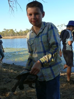 Thomas catches a turtle in the lagoon