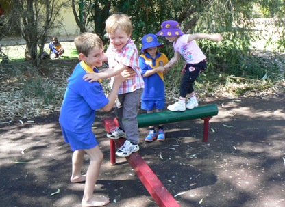 Hugh assisted by Connor on the balance beam